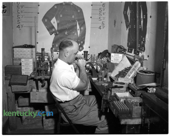 Patrolman Wallace McMurray reloading amunition in the basement of the offices of the Lexington Police Department, June 7, 1949. Under a new program, all officers go through pistol practice and to reduce cost, McMurray is responsible for melting and casting bullets and re-loading and re-priming empty cartridge cases for the officers. The equipment he is using was recently purchased to keep up with the demand of the training. Published in the Lexington Leader June 8, 1949.