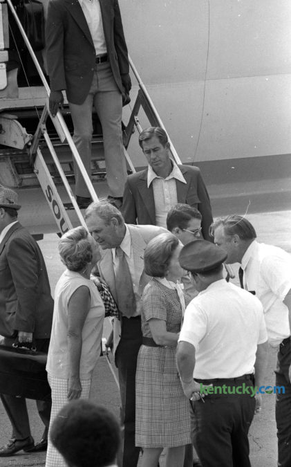 Alabama Football Coach and Athletic Director Paul Bear Bryant greets Mrs. Charles Mitchell of Lexington after arriving at Blue Grass Field Sept. 21, 1973. The trip marked the first time Bryant, who coached at Kentucky for eight winning seasons, brought a team into Lexington to face the Wildcats. Bryant coached at UK from 1946-1953 before leaving for Texas A&M. He later went to Tuscaloosa was the legendary coach of Alabama for 25 years, leading the Crimson Tide to six national titles. Behind Bryant is Alabama basketball coach C.M. Newton, who came to Alabama after coaching at Lexington's Transylvania College for 12 seasons. After leaving Lexington in 1953, Bryant had a good relationship with Kentucky basketball coach Adolph Rupp and in 1969 he took Rupp's advice in hiring Newton to revive Alabama's basketball program. Newton went on to lead the Tide to three straight SEC titles. After a 30 year coaching career, he came back to Lexington in 1989 to be the athletic director at his alma mater, UK, where he served for 11 years. As for the game the following day, a Commonwealth Stadium record crowd of 54,100 chanted "Beat Alabama" and "Let's skin the Bear" to welcome back their former coach. Despite taking a 14-0 lead at the half, UK lost to heavily-favored Alabama, 28-14. Photo by E. Martin Jessee | staff