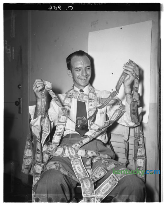 William Nash Payne was photographed wrapped up in 101 feet of dollar bills  as he was slowing moving toward his goal of 5,280 feet as his part of the Epworth Methodist church's building fund in August 1948. So far Nash had collected $203 or 101 feet of bills. A mile will amount to $10,000. Published in the Lexington Herald August 19, 1948. Herald-Leader Archive Photo