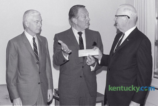 Art Linkletter, center, author and TV personality, presented a check for $250 to Fred Bryant, right, chairman of the board of Shriners Hospital for Crippled Childrena At left is William T. Young, Lexington businessman and chairman of the board of directors of Royal Crown Cola, which sponsored Linkletter's visit. Linkletter, a member of the board of Royal Crown Cola was in Lexington for two speaking engagements January 15, 1968. Herald-Leader Archive Photo