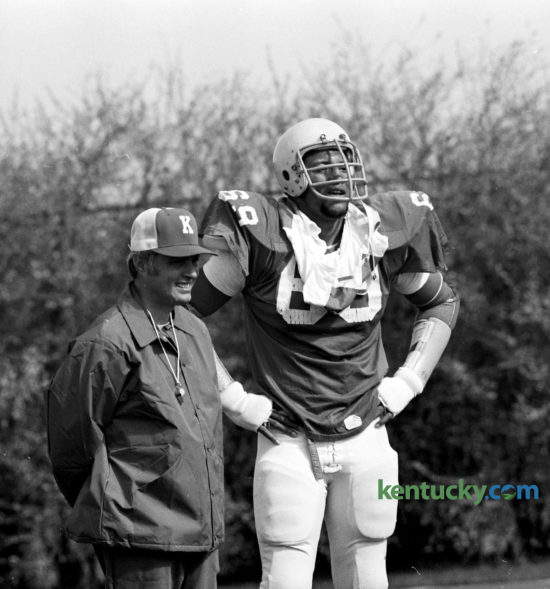 University of Kentucky football coach Fran Curci looked on with his star, Warren Bryant as the Wildcats formally opened their spring practice, March 6, 1976. The offensive tackle became a cornerstone of Kentucky’s 1976 SEC co-championship team. But the Cats were not crowned co-champions until 1978 because Mississippi State was forced to forfeit all its games from 1976 because of an ineligible player. It is the most recent SEC football championship for UK. Bryant went on to be the sixth overall pick in the 1977 NFL Draft by Atlanta. The 6-foot-6, 273-pound Florida native went on to play 164 games, starting 93, in the NFL. During Bryant’s time in Atlanta (he also played five games with the Raiders), the Falcons made the playoffs for the first time in franchise history (1978). Photo by E. Martin Jessee | Staff