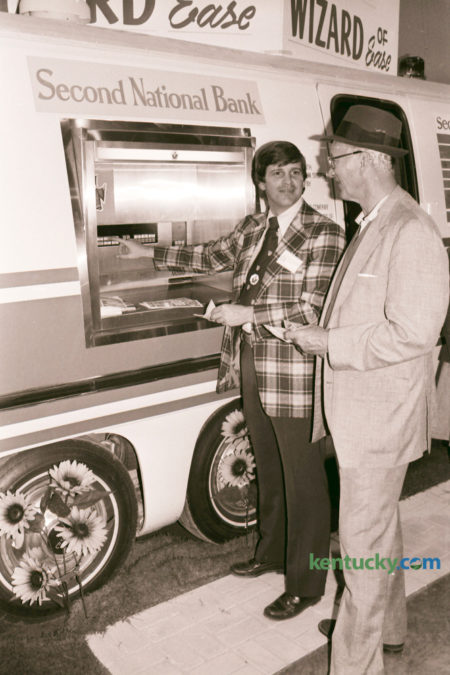 The first event held at the new Lexington Center in October 1976 was the Central Kentucky Expo, which featured industries and businesses of the area and included tours of the center and Rupp Arena. The Expo, held October 8-10 included the introduction of the automatic teller machine by Second National Bank. John Holmes, left, with the bank demonstrated the new machine to Gene Bryant. The bank announced that the automatic teller machines would be operating at the Woodpile and Fayette Mall branches by November 1. Photo by David Perry | Staff