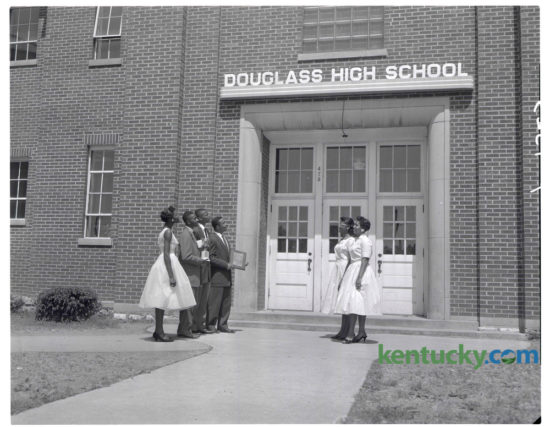 Top honor seniors got together after the annual Award Day program at Douglass High School to admire the $200 name plaque their graduating class presented to the school at Class Night exercises on Monday May 26, 1958. Honor members of the senior class which "did something" about the fact that Douglass had never had a name marker over its front doors, include, from left, Charlesanna Brown, Delta Sigma Theta sorority $100 scholarship; Randolph Stewart, salutatorian, Female Education Society $100 scholarship and Alpha Phi Alpha fraternity award; Lonny Demaree, third-honor student; James Barlow Jr., valedictorian, Watkins English Plaque; June Taylor, leader award, and Carolyn Dawson, Female Education Society $100 scholarship. The name plaque was installed with neon lighting. Herald-Leader Archive Photo