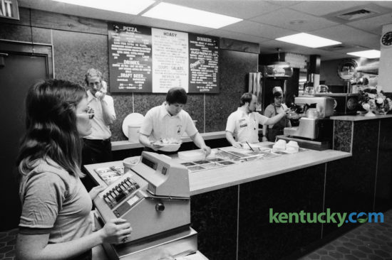 Lexington's second LaRosa's Restaurant location opened in the Coliseum Plaza, corner of Rose Street and Euclid Avenue in early February 1975. The popular Cincinnati-based restaurant featured big backed booths and stucco walls. Preparing to serve customers were, from left, Diana Cagle, Jim Hoff, manager, Lance Churchill, co-owner, and Kirk Seeberger, co-owner. The first Lexington LaRosa's location opened in Woodhill Shopping center in 1974. Both locations were closed before 1979.  Photo by Frank Anderson | Staff