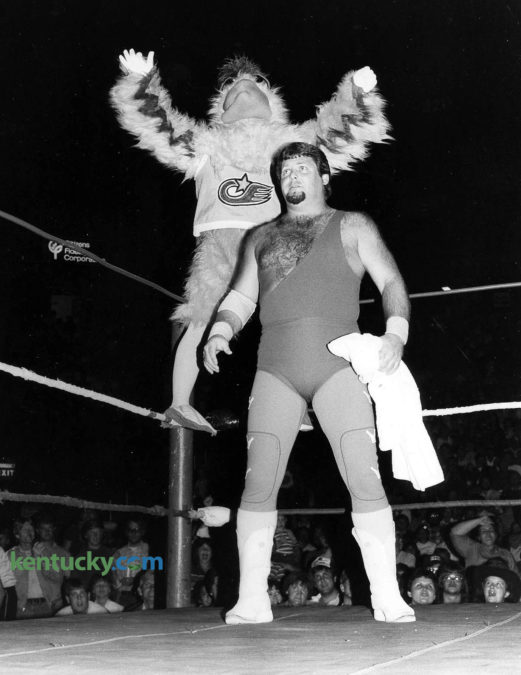 The San Diego Chicken with wrestler Jerry "The King" Lawler before the A.W.A Southern Heavyweight Championship match Oct. 6, 1983 at Rupp Arena. Tickets were $7 for ringside seats, $6 for general admission to see the famous mascot as Lawler's manager. The wrestling legend was facing another legend, Jessee "The Body" Ventura, who was managed by Jimmy Hart. Lawler won, and as part of a bet, Hart had to wear a chicken suit. After putting on the suit, The Chicken hit him with a flying drop kick that made his feathers fly. Eight days later, The Chicken - one of the most influential mascot in sports history - appeared at a University of Kentucky volleyball game. At 9 p.m. on Oct. 14, a record 7,830 fans paid $1 to see No. 5 UK lose to No. 1 Hawaii in Memorial Coliseum. Three hours later, Wildcats coach Joe B. Hall held the second ever Midnight Madness, the annual first basketball practice of the season. Photo by Tom Woods.