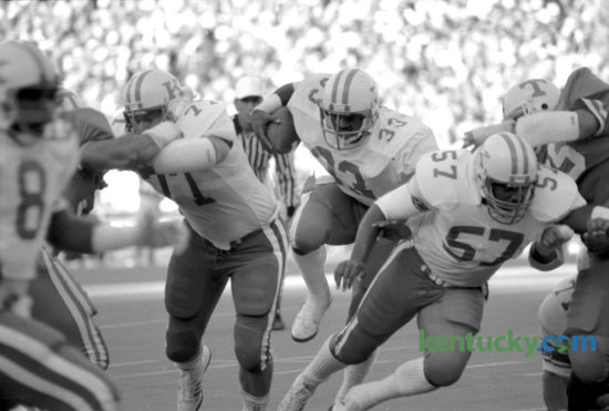 Kentucky running back George Adams (33) broke through the line in UKÕs last win over Tennessee, Nov. 24, 1984 in Knoxville.  The Wildcats prevailed 17-12. Adams, the tailback from Lexington rushed for 110 yards and two touchdowns. Kentucky finished their season under coach Jerry Claiborne 9 and 3 and beat Wisconson in the Hall of Fame Bowl in Birmingham 20-19. Photo by Tom Woods | Staff