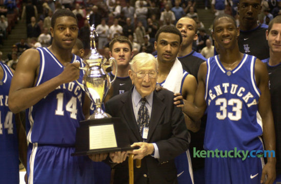 Legendary and former coach of UCLA John R. Wooden held the game trophy with the UK team after the Wildcats  beat the Bruins 52-50 in the John R. Wooden Classic on Dec. 6, 2003, in Anaheim, Calif. UK players in front include, from left, Erik Daniels, Gerald Fitch and Antwain Barbour. The 2016 version of the matchup is Saturday, as Kentucky hosts UCLA in Rupp Arena at 12:30 p.m. Photo by David Stephenson | Staff