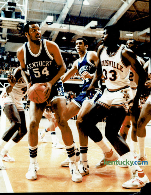 University of Kentucky's Melvin Turpin, left, who totaled 18 points and a game high 9 rebounds, looked to fake University of Louisville's center Charles Jones during the first "Dream Game" in recent history, between the two schools, at the NCAA Mideast Regional in Knoxville, March 26, 1983. The Wildcats fell 80-68, after being outscored 18-6 in overtime. Photo by Charles Bertram | Staff