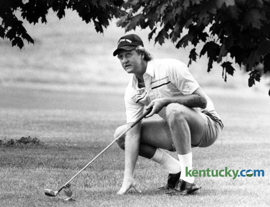 Basketball legend Larry Bird ducked under some trees to line up a golf shot June 30, 1984 during the 3rd annual Children's Charity Golf Classic at the Greenbrier Golf and Country Club. Bird, who recently led the Boston Celtics to the NBA championship, was playing for only the second time this season. He finished with a respectable 84 and led his team to a sixth-place finish at 25 under. "It went pretty good for the first 10 or 12 holes," Bird said. "Then I just blew up. I played nine holes yesterday and that was the first time I've played this year. But this is a really beautiful course to play." Actor Leslie Nielsen and four other golfers combined for a 31- under total 113 to win the event. The scores were taken from the best two balls of each hole with each player's handicap figured in. The tournament, featuring Phoenix Suns' and ex-Cat Rick Robey as host, raised $56,000. The money benefits the Children's Charity Fund of the Bluegrass and is still played today. Bird, an Indiana native who went on to win three NBA titles and three league MVP's, recently turned 60. Photo by Steven R. Nickerson | Staff