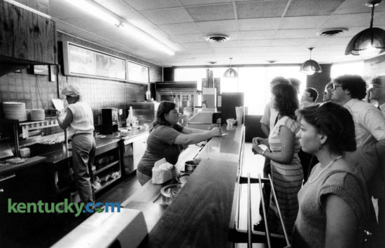 Ellen Johnson, center, took orders at the counter of Lexington's Tolly-Ho restaurant, on the last day at its original location, Mat 11, 1985. The popular campus hangout near the University of Kentucky, has been a Lexington institution since 1971 when they opened at their first location at what was then 108 W. Euclid, today known as Winslow St. In March of 1985, the 24-hour greasy spoon couldn't make a deal for a new lease and relocated in August 1987 around the corner at 395 S. Limestone. They rented there until in May 2011 when they opened at their current location, purchasing the empty Hart's Dry Cleaning building at 606 South Broadway. At the original location shown here, they sold two eggs and toast and jelly for 99 cents. But a quarter-pound hamburger, known as a Tolly, outsold everything else on the menu 10 to 1. Photo by J.D. VanHoose | staff