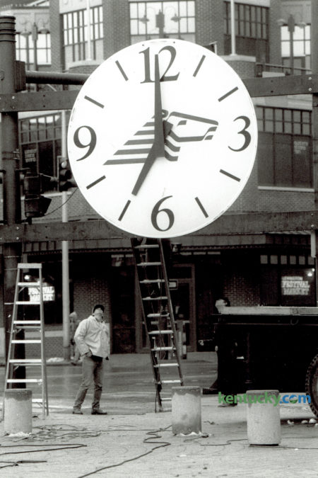 Dave Stevens, left, an electrician for the city of Lexington, and Robert Defino, right, of Smither Sign Company, peered up at a large clock to be used for the New Year's Eve countdown in Triangle Park December 31, 1989. Photo by J.D. VanHoose | Staff