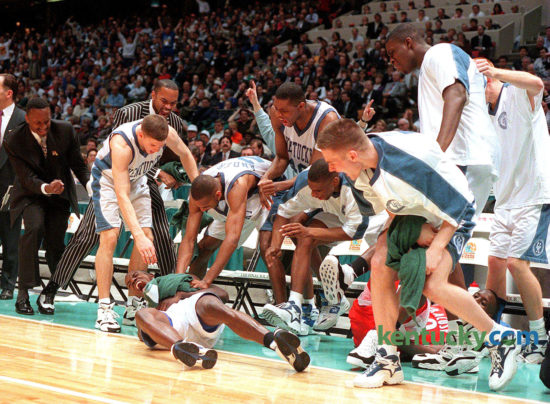 Tony Delk, lying on the floor, is mobbed by teammates after he was fouled while hitting a 3-pointer during Kentucky's 76-67 win over Syracuse in the NCAA championship game, April 1, 1996 in East Rutherford, N.J. Leading the Cats to their sixth national title, Delk tied a championship-game record with seven 3-pointers in the game. At the behest of ex-Kentucky guard Cameron Mills, filmmaker Jason Epperson and WKYT-TV’s Dick Gabriel have combined to produce a documentary on Kentucky’s 1996 NCAA championship team. The film will debut on Lexington’s WKYT-TV at 5 p.m. Christmas Day. “They really believe they were the best team in the modern era of college basketball,” Gabriel said. Photo by Daqvid Perry | staff