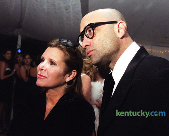 Actress Carrie Fisher, with novelist Bruce Wagner, attending a Kentucky Derby party April 30, 1999 at the Kentucky Horse Park in Lexington. At the party, as a reporter was starting to ask her about the upcoming release of Star Wars: Episode I - The Phantom Menace, Fisher interjected: "No, I have not seen it. I can always tell the face they make before they ask about it." Despite being forever linked to the Star Wars trilogy and the accompanying hype of the new film, Fisher said: "I can't get sick of it. That would be a bad choice to make." Fisher, who died Dec. 27, 2016 was attending her first Derby the following day in Louisville. Photo by Jahi Chikwendui | staff