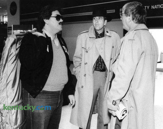 Sportscaster Brent Musburger, center, waits for his luggage March 27, 1985 after arriving at Lexington's Blue Grass Airport for the NCAA Final Four at Rupp Arena. The lead voice for CBS Sports was greeted by NCAA hospitality volunteers as soon as he stepped off the plane, thrusting a tray of brightly wrapped candies towards him. "Welcome to God's country. Have a bourbon ball," Pat Shropshire, the head of the airport hospitality committee urged in her best welcome-to-Lexington voice. No sooner had Musburger sidestepped the sweets than an eager army of volunteers surrounded him, dispensing NCAA buttons, patches and directions. He was among the first large group of tournament visitors to arrive in Lexington. Other passengers on Musburger's flight got the same treatment, and many appeared bewildered by the hearty hellos. Five days later, Musburger did play-by-play while Billy Backer provided color commentary on Villanova's historic NCAA championship upset over heavily-favored Georgetown. Photo by Christy Porter | staff