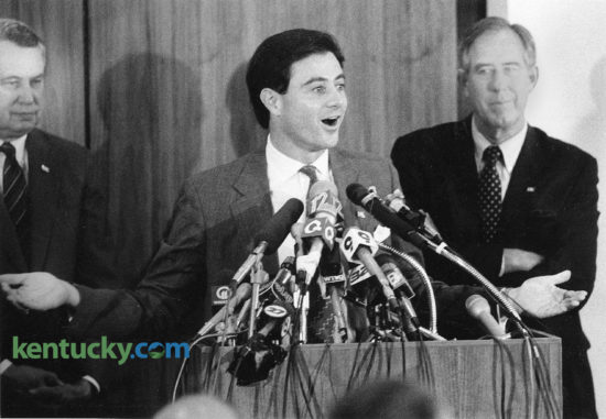 Rick Pitino during his introductory news conference as the University of Kentucky basketball coach, June 1, 1989. Behind Pitino to the right is the man who hired him, first year athletic director C.M. Newton. The 36-year-old coach of the NBA's New York Knicks said he was up to the challenge of guiding Kentucky out of cloud of NCAA sanctions. "Sanctions and probations just make it a little bit tougher," Pitino said in a Patterson Office Tower board room packed with reporters, 15 television cameras and UK officials. "But we will overcome all obstacles in making Kentucky basketball rich again." Kentucky faced a ban on post-season play for two years, a ban on live television appearances in 1989-90 and scholarship reductions resulting from an investigation that unveiled such NCAA rules violations as the sending of $1,000 to a recruit's father and cheating on a college entrance exam. Newton called Pitino's hiring the "first step in rebuilding the basketball program." In his remarks Pitino referred to a recent Sports Illustrated cover story, headlined "Kentucky's Shame," that outlined the UK program he inherited. "I promise to you people in this room today you'll see Kentucky on the cover of Sports Illustrated once again," Pitino said, "and it will be cutting down certain nets. It won't be for what you saw last week." Photo by David Sterling | staff