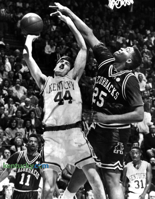 University of Kentucky forward Gimel Martinez puts up a shot over Arkansas center Oliver Miller during the Razorbacks 105-88 win over the Cats, Jan. 25, 1992 at Rupp Arena. The long-awaited showdown between the two top-ten teams was the first meeting in league play since Arkansas joined the Southeastern conference. A record Rupp Arena crowd of 24,324 and what Arkansas Coach Nolan Richardson called "the atmosphere of the Final Four" had no discernible impact on the senior-dominated Razorbacks, who held UK star Jamal Mashburn to a season-low four points, snapping a string of 19 double-figure games. Photo by Frank Anderson | staff