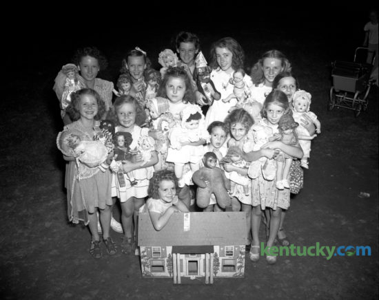 A group of the first-place winners in the Castlewood section of the city-wide doll show August 8, 1947, were shown with their prize-winning prettiest, ugliest, biggest, smallest or otherwise dolls.  Shown with her doll house is Mary Ann Hubbuch; first row, left to right,  Margaret Marie Sweeney, Elizabeth Gayle Mount, Phyllis Jean Pridemore, Patsy Jo Garrison, Jo Ann Cox and Juanita Garrison; second row, Sally Ann Carlin, Mary Anne Davidson, Eudean Bowling, Mary Ann Graves, Pauline Garrison and Glenna Davidson. Published in the Lexington Herald-Leader August 10, 1947. Herald-Leader Archive Photo