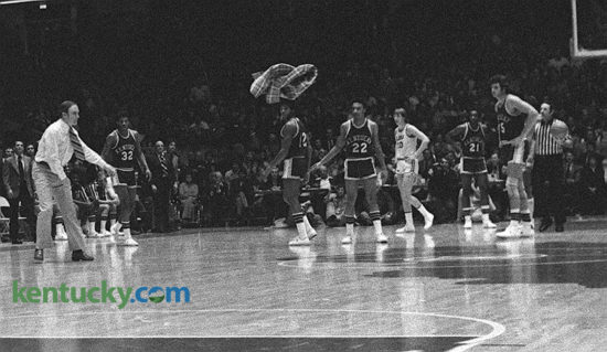 A frustrated LSU coach Dale Brown tossed his plaid sportcoat onto the Kentucky emblem at midcourt in a Feb. 2, 1976 Memorial Coliseum game that was marred by four technical fouls, 53 fouls, 63 free-throw attempts, a six-minute stoppage in play that resulted in a five-point play and Brown being escorted from the game officials' locker room by a university police officer. The Tigers started the game hot and had a 34-21 lead after Kenny Higgs' five-point play. Kentucky's Larry Johnson fouled Higgs hard on a made basket and was assessed a technical. UK coach Joe B. Hall was given a technical after saying the call was "horse manure", or words to that effect. "They (the officials) don't realize that's not a dirty word in the Bluegrass," Hall joked after the game. After the delay, UK started a comeback, one that Brown felt was helped by the officials, culminating with his double technicals in the second half. "Joe Hall won the game and he should be complimented," Brown later said. "He intimidated the officials." Immediately after the game Brown followed the officials to their small dressing room under the Coliseum. The coach didn't bother to close the door as he said, "Reggie (Copeland), you let them call you an S.O.B. (an epithet emphatically denied by Hall) and you didn't have the guts to throw him out! You let an assistant coach bat the ball halfway across the floor!" A campus policeman then entered the room to escort Brown out. "Get your arm off me, fella," Brown said. "These guys (the campus police) are as bush league as they are (the officials)!" Brown later went to the UK locker room to shake Hall's hand. "I could match every complaint he had," Hall said. "After the game he was complaining generally about the officials and I was generally agreeing with him." Photo by E. Martin Jessee | staff