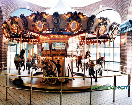 The carousel in Festival Market, now called Triangle Square, July 25, 1994, three days after it and the building was sold at auction. The 22-foot-wide, 12-horse carousel was bought by politician and Lexington caterer Jerry Lundergan for $35,000. He tried to sell it to the Lexington Children's Museum for the same price he paid for it. Mayor Pam Miller said the city had considered buying the carousel for the museum but they didn't have the money to buy it or someone to run it and "there is no extra space in the Children's Museum," she said. Lundergan eventually sold the carousel to Tom's Farms, a produce and amusement complex in Corona, Calif. It is still in use there today. "It's a beautiful piece of equipment," Lundergan said after the auction for the carousel, which was built in San Francisco in 1986. "It was the showpiece of Festival Market." The carousel was always popular and added to the vibrancy of the mall, said Dudley Webb, partner with the Webb Cos. which developed the downtown Lexington shopping center. The $16 million, three-story mall opened in 1986 as Lexington Festival Market, designed as an upscale center with dozens of shops and restaurants. While children rode the merry-go-round on the top floor, a jazz pianist played lunchtimes in the courtyard below. However, the mall, which was expected to have up to 70 businesses, never found its niche and has lost money each year since it opened. At the time of the auction, the it was in the midst of converting from an upscale center to a factory outlet mall. Developed by the Webb Companies in partnership with Kentucky Central Life Insurance Co., the mall became a casualty of the failure of Kentucky Central. When the insurance company failed in 1993, the mall was placed in receivership. The estimated debt of the mall was more than $13 million, according to court records. The Webbs had managed the mall since it opened but gave up, citing frustration over efforts to revitalize it. A judge's order dissolved the pa